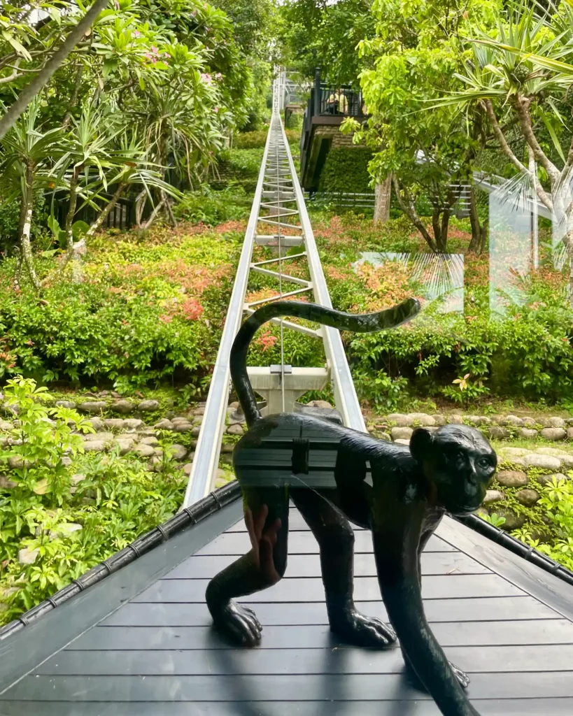 A Return to InterContinental Danang Sun Peninsula Resort funicular going up to the lush mountain with monkey statue